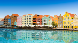 Colorful buildings on water's edge.