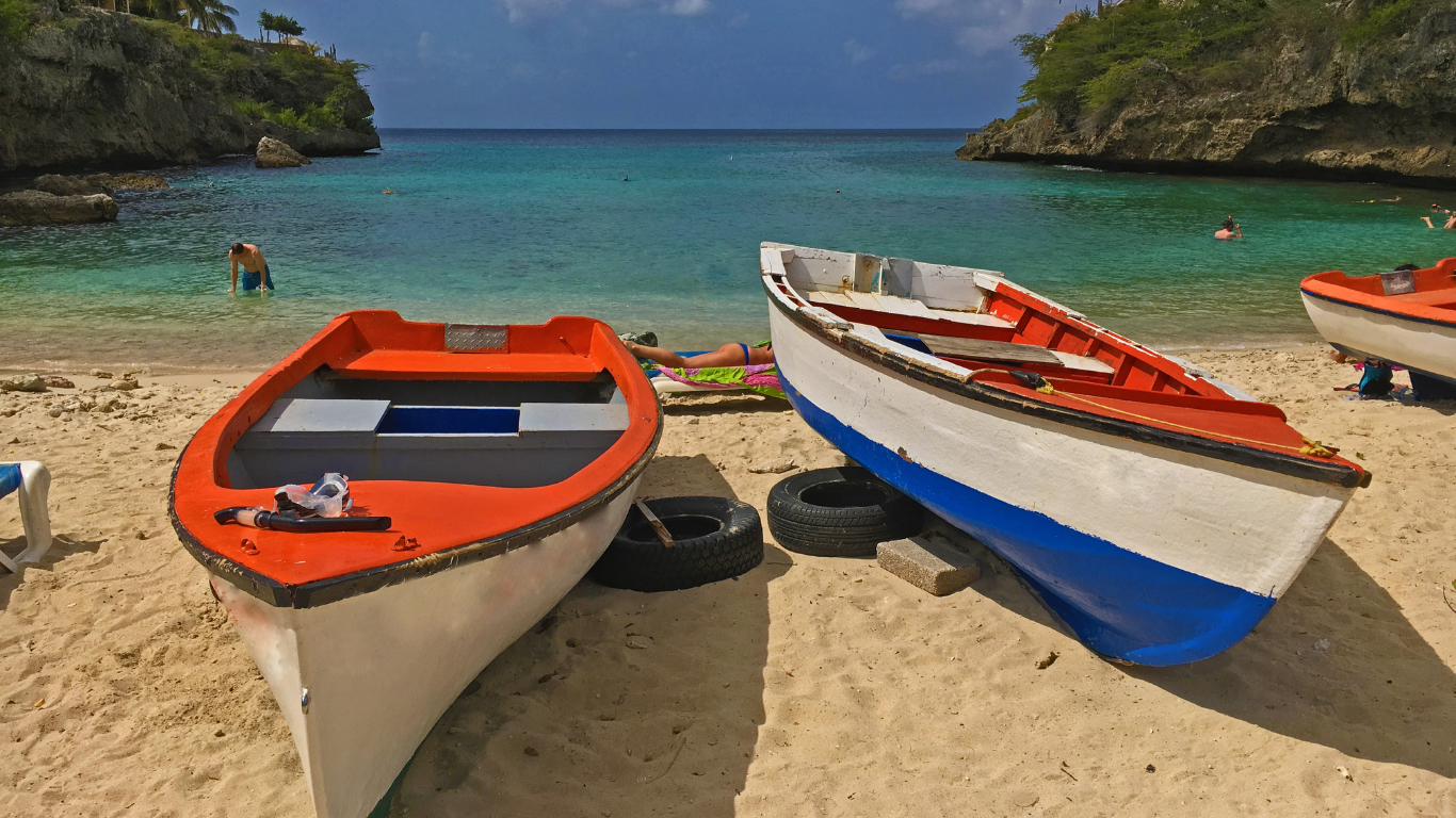 Three wooden small boats on the beach