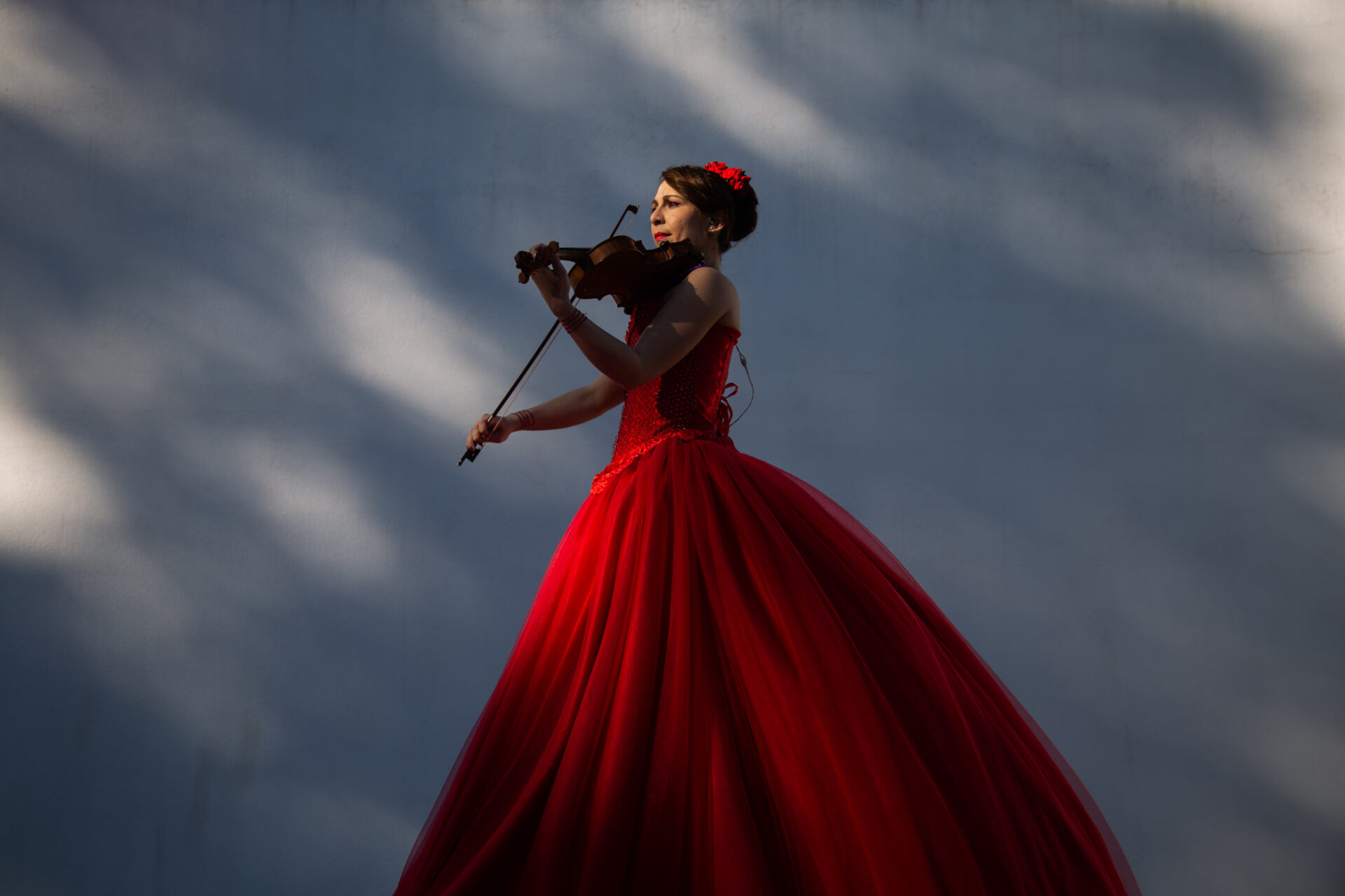 Female violinist in red gown.