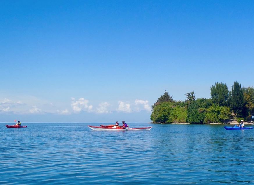 Kayaking on Lake Kivu in Rwanda, an adventurous water activity surrounded by scenic hills and serene waters, perfect for eco-tourism and outdoor exploration in East Africa.
