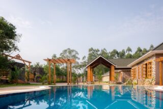 Luxury safari lodge near Kibale Forest offering eco-friendly accommodations, chimpanzee trekking, and immersive wildlife experiences in lush tropical surroundings.