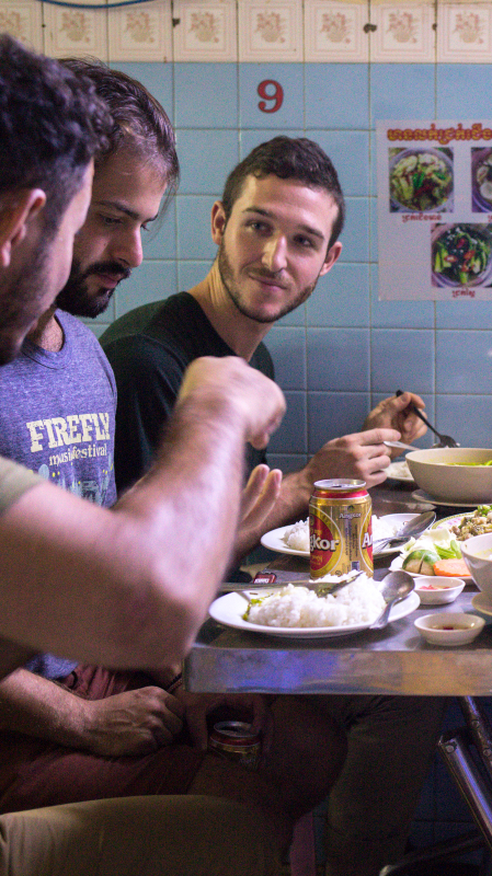 Travelers eating market street food