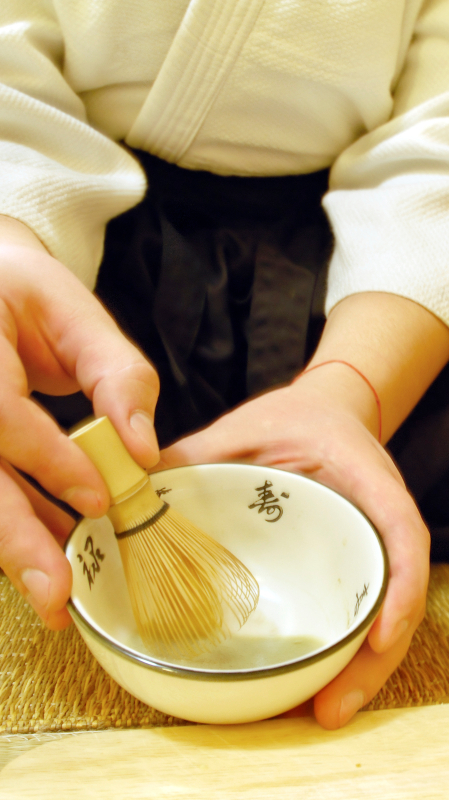 Mixing tea in a small bowl