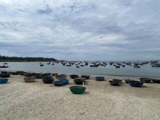 Danang beach landscape with traditional boat.