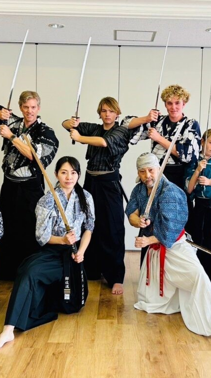 Guests posing with samurai blades