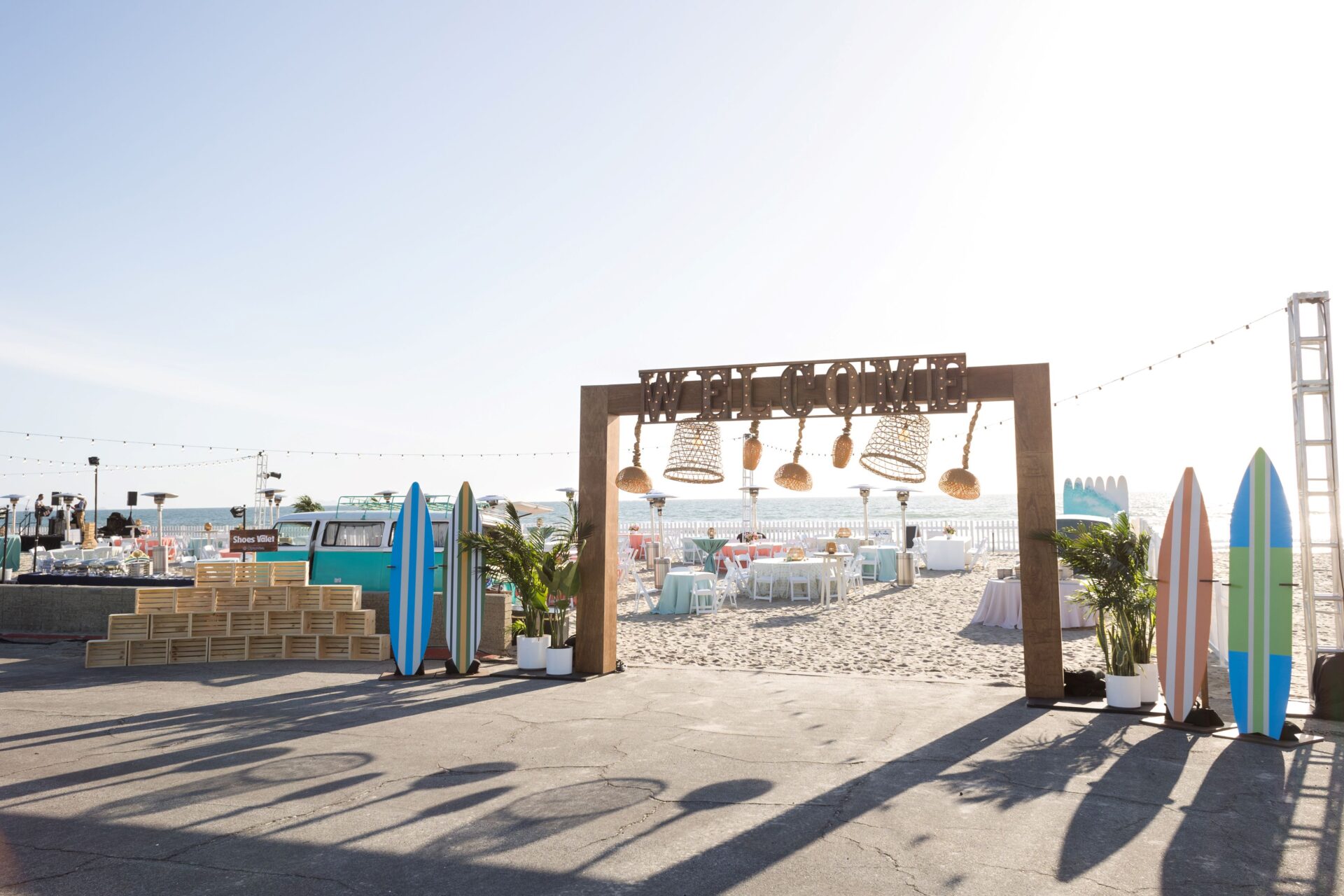 Welcome sign on the beach with surf themed decor