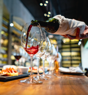 red wine pouring into a glass for a tasting