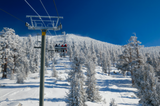 people on a ski lift with snow on the ground