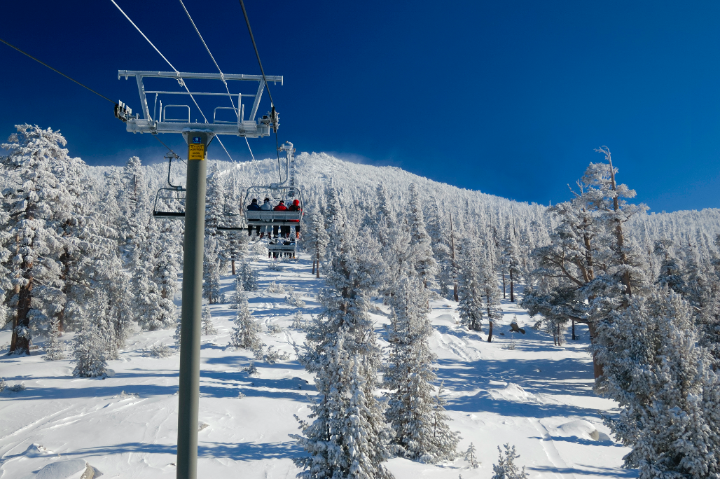 people on a ski lift with snow on the ground