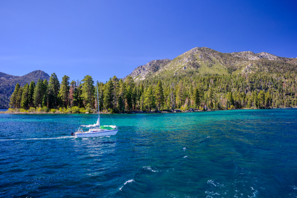sailboat on Lake Tahoe with mountains in the background.