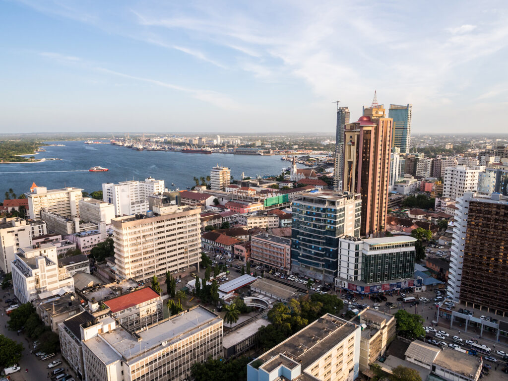 Aerial view of Dar es Salaam, Tanzania’s bustling coastal city, featuring modern architecture, beaches, and vibrant markets—a key East African destination for business, culture, and tourism.