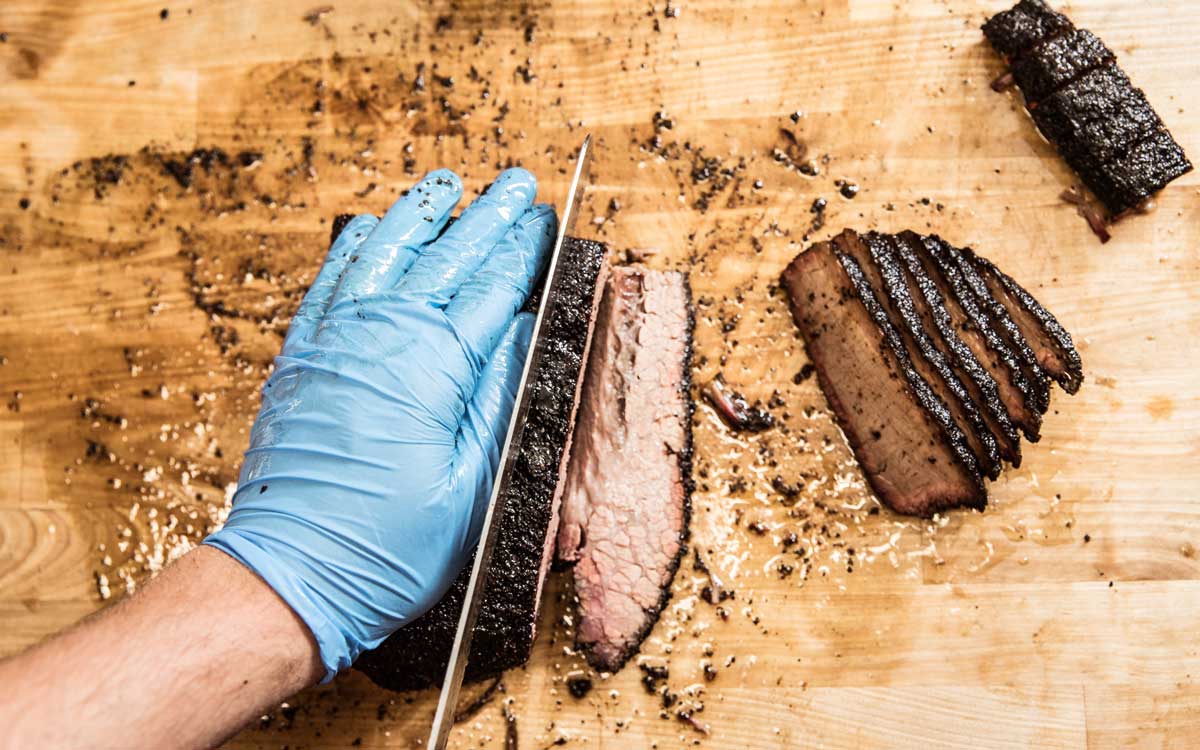 Person slicing a brisket