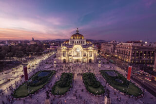 Fantastic view Mexico City's downtown at twilight. The nightlife of the city can be seen around the Palacio de Bellas Artes building in foreground.