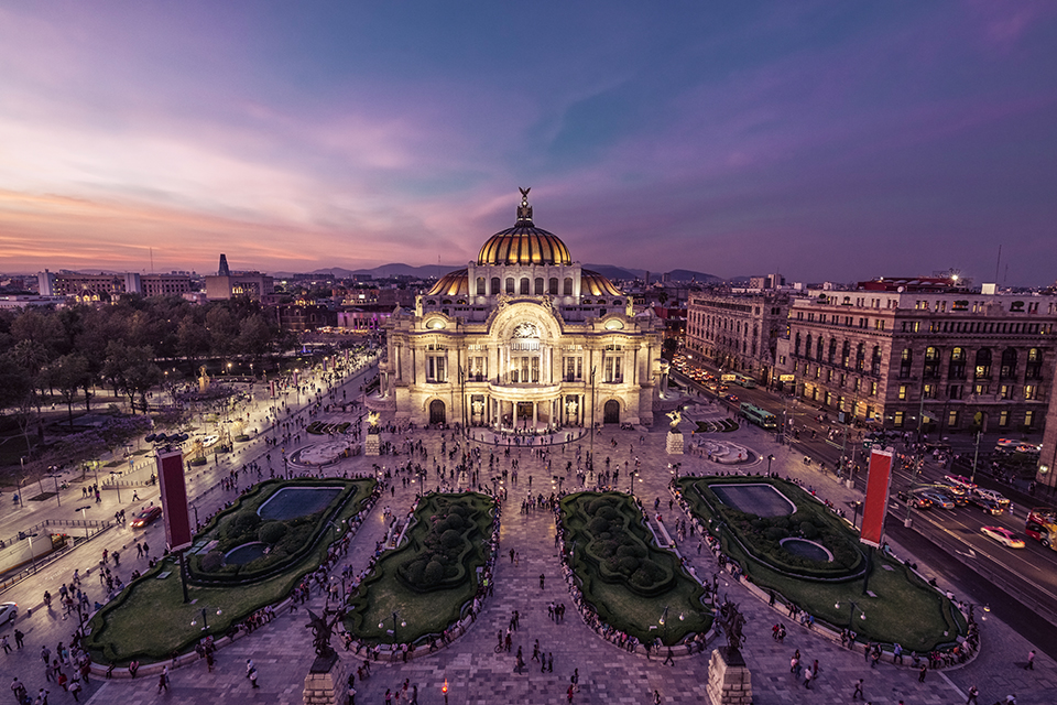 Fantastic view Mexico City's downtown at twilight. The nightlife of the city can be seen around the Palacio de Bellas Artes building in foreground.