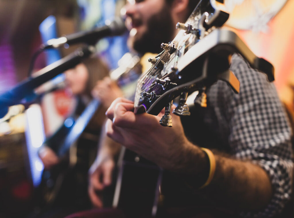 close-up-of-man-playing-classic-guitar