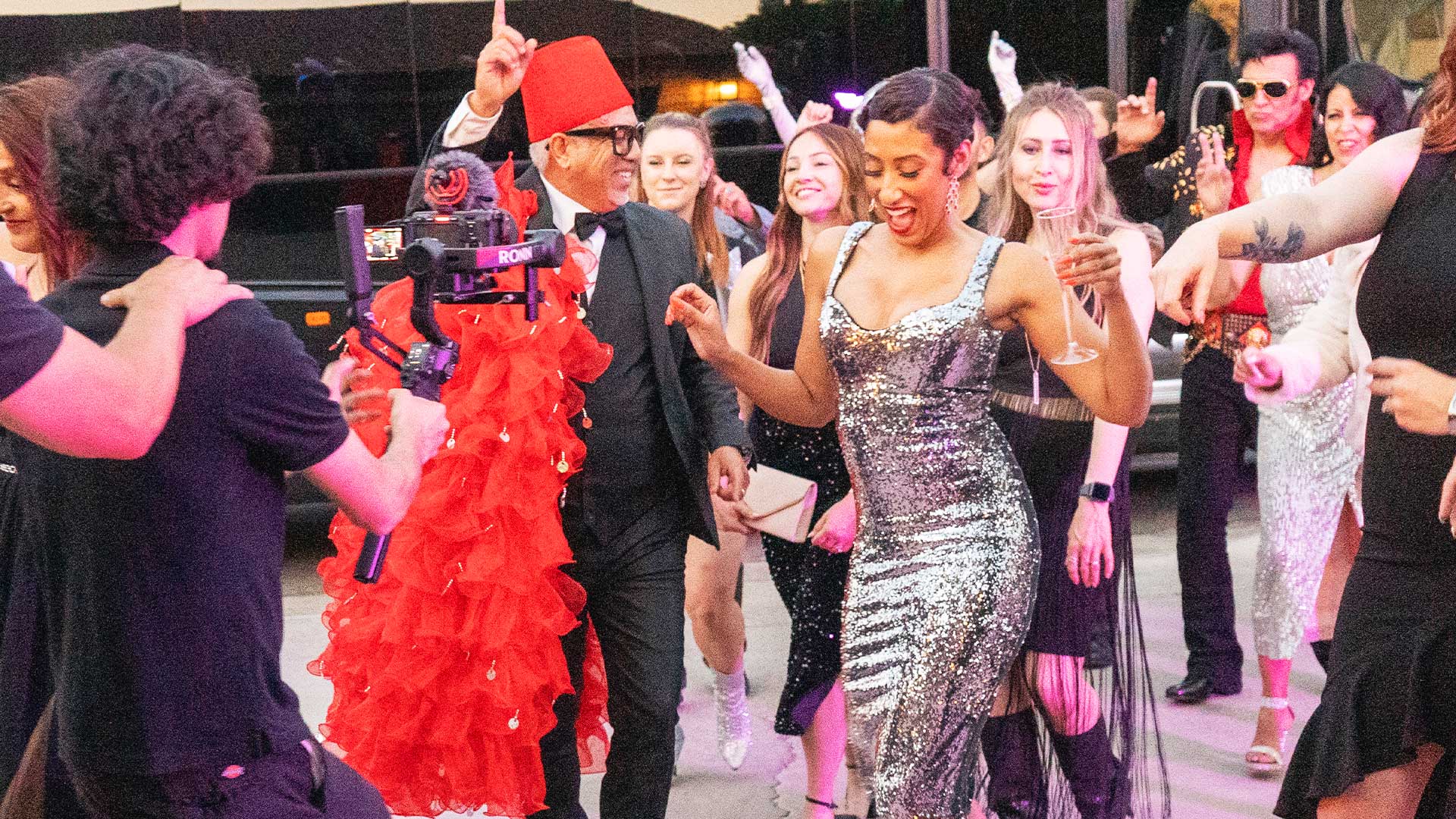 A lively group of guests dancing at a Destination Fabulous event, featuring vibrant outfits and joyful expressions