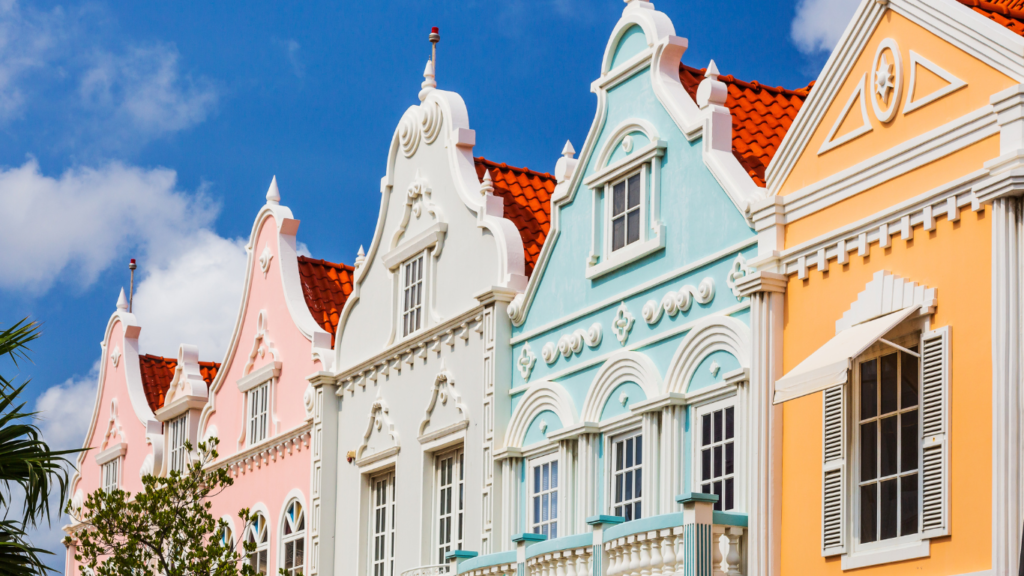 Pink, green & grey pastel painted buildings of Aruba