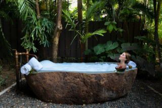 Woman soaking in stone tub at Dorado Reserve