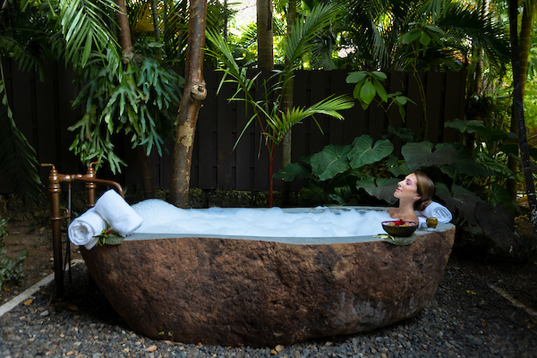 Woman soaking in stone tub at Dorado Reserve