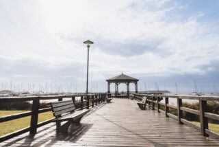 Wooden pier with benches and a gazebo in Punta del Este