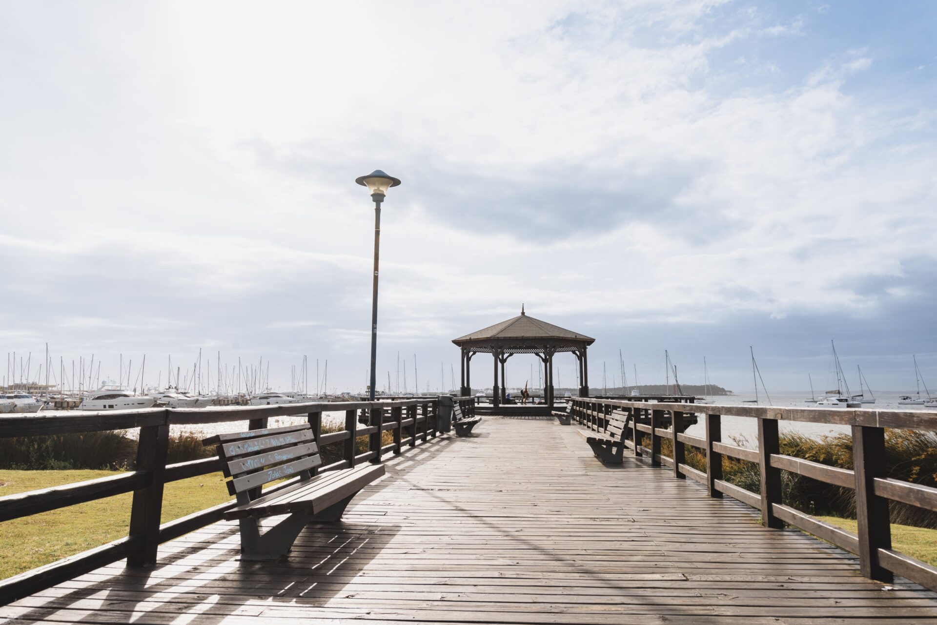 Wooden pier with benches and a gazebo in Punta del Este