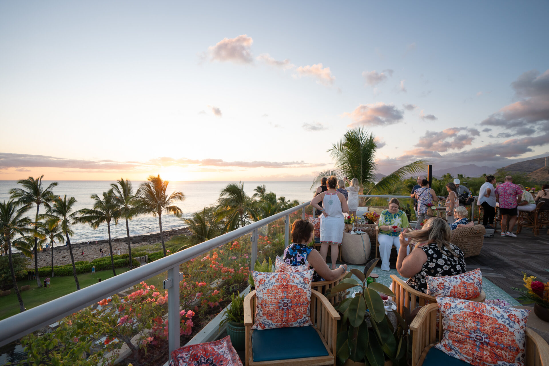 People gathered on a rooftop bar and lounge at the Four Seasons Resort Oahu at Ko Olina