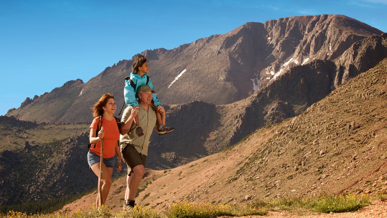 A family of three hiking in Pikes Peak