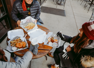 People enjoying food at an eatery