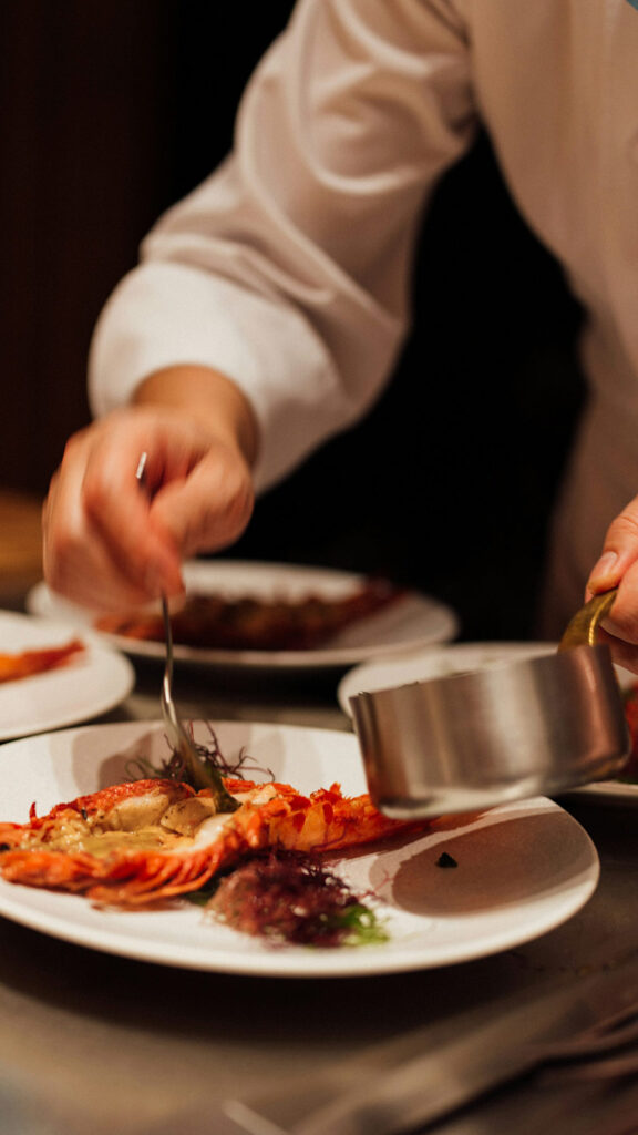 Gastronomic Experience. Chef plating a meal.