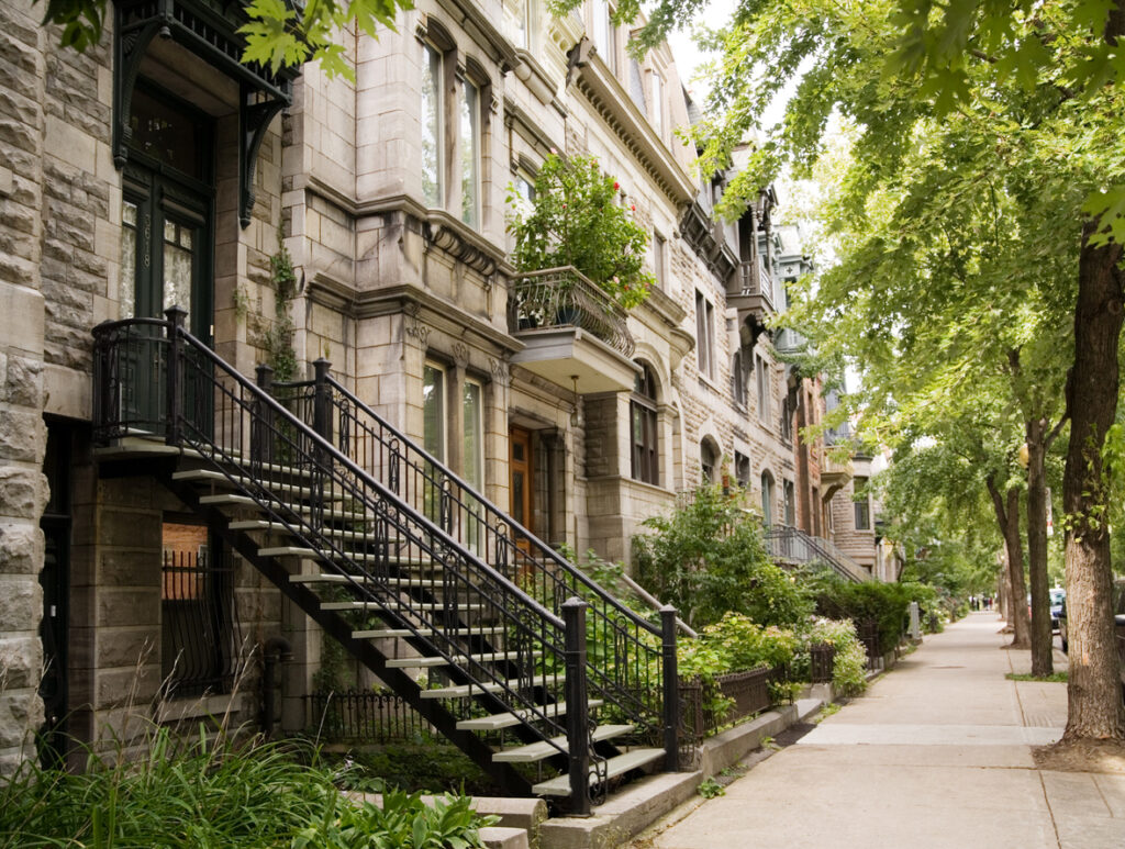 Town houses on a tree-lined street.